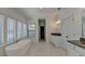 Bright bathroom showcasing double sinks, soaking tub, marble floors, and large windows at 3856 Allegretto Cir, Atlanta, GA 30339