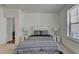 Bright bedroom with a queen bed, neutral carpeting, and two nightstands with lamps at 3856 Allegretto Cir, Atlanta, GA 30339