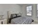 Comfortable bedroom featuring a stylish bed, two modern nightstands, and bright windows at 3856 Allegretto Cir, Atlanta, GA 30339