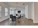 Open dining room with modern chandelier and furniture next to the bright living room at 3856 Allegretto Cir, Atlanta, GA 30339