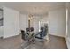 Dining room with an open concept that leads to the modern, white kitchen with stainless appliances at 3856 Allegretto Cir, Atlanta, GA 30339