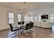 Open concept living and dining area with gleaming hardwood floors and bright, natural light at 3856 Allegretto Cir, Atlanta, GA 30339