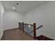 Hallway features hardwood floors, white walls, wood banister with black iron spindles, and recessed lighting at 3856 Allegretto Cir, Atlanta, GA 30339