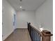 Hallway features hardwood floors, white walls, wood banister with black iron spindles, and recessed lighting at 3856 Allegretto Cir, Atlanta, GA 30339