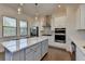 Modern kitchen with white cabinets, stainless steel appliances, and large island with room to eat at 3856 Allegretto Cir, Atlanta, GA 30339