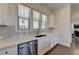 Kitchen featuring stainless steel dishwasher and white cabinets with contrasting dark hardware at 3856 Allegretto Cir, Atlanta, GA 30339