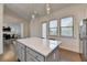 Bright kitchen island with quartz countertops and stainless appliances offers style and functionality at 3856 Allegretto Cir, Atlanta, GA 30339