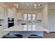 Kitchen featuring a large island, quartz countertop, pendant lighting, and stainless steel appliances at 3856 Allegretto Cir, Atlanta, GA 30339