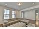 Cozy living area featuring a sectional couch, recessed lighting, and windows providing natural sunlight at 3856 Allegretto Cir, Atlanta, GA 30339