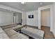 Well-lit living room with hardwood floors, a cozy sectional sofa, and an entertainment area with a mounted television at 3856 Allegretto Cir, Atlanta, GA 30339