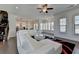 Bright open living area adjacent to staircase and open-concept kitchen and dining areas at 3856 Allegretto Cir, Atlanta, GA 30339