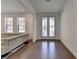 Bright living room with hardwood floors, double doors, and neutral paint at 3856 Allegretto Cir, Atlanta, GA 30339