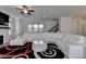 Spacious living room area with fireplace, dark floors and staircase leading to the second floor at 3856 Allegretto Cir, Atlanta, GA 30339