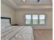 Main bedroom with carpet, tray ceiling, recessed lights, and three windows with wooded view at 3856 Allegretto Cir, Atlanta, GA 30339