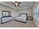 Main bedroom has a tray ceiling, carpet, ceiling fan, and a dresser with mirror at 3856 Allegretto Cir, Atlanta, GA 30339