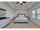 Bright main bedroom featuring a tray ceiling, carpet, ceiling fan, and a dresser at 3856 Allegretto Cir, Atlanta, GA 30339