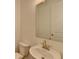 Compact powder room features a modern pedestal sink, mirror, and standard toilet at 3856 Allegretto Cir, Atlanta, GA 30339