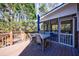 View of screened porch and spacious deck with outdoor furniture and wood railings at 6507 Bennington Dr, Tucker, GA 30084