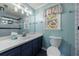 Bright bathroom with a large mirror, white countertop, blue vanity, and modern fixtures at 6507 Bennington Dr, Tucker, GA 30084