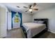 Bedroom with blue curtains, a ceiling fan, and a comfortable bed in a naturally lit room at 6507 Bennington Dr, Tucker, GA 30084