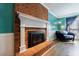 Attractive red brick fireplace framed by white paneling with mantle in a living room with wood laminate flooring at 6507 Bennington Dr, Tucker, GA 30084