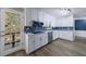 Modern kitchen with white cabinets, stainless appliances, blue tile backsplash and door leading to a deck at 6507 Bennington Dr, Tucker, GA 30084