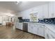 Well-lit kitchen featuring white cabinetry, stainless steel appliances, and a subway tile backsplash at 6507 Bennington Dr, Tucker, GA 30084