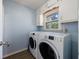 Functional laundry room featuring a washer, dryer, and upper cabinets for storage at 6507 Bennington Dr, Tucker, GA 30084