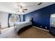 Main bedroom with a dark blue accent wall, a large window, and comfortable furniture at 6507 Bennington Dr, Tucker, GA 30084