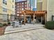 Community grilling area with pergola, seating, and barbecue grills at 800 Peachtree Ne St # 8415, Atlanta, GA 30308