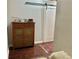 Entryway featuring hardwood floors, a cabinet, and a sliding barn door at 800 Peachtree Ne St # 8415, Atlanta, GA 30308