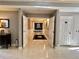 Wide hallway with marble-look tile flooring, neutral paint, and elegant lighting fixtures at 800 Peachtree Ne St # 8415, Atlanta, GA 30308