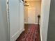 Hallway with hardwood floors, a red patterned rug, and a modern chandelier at 800 Peachtree Ne St # 8415, Atlanta, GA 30308