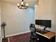 Well lit home office space with wooden desk and decorative chandelier at 800 Peachtree Ne St # 8415, Atlanta, GA 30308