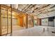 Unfinished basement with exposed framing, concrete floor, insulated ceiling, and walkout access to the backyard at 1151 Nash Lee Sw Dr, Lilburn, GA 30047