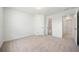 A carpeted bedroom offers natural light, a closet, and easy access to other rooms at 1151 Nash Lee Sw Dr, Lilburn, GA 30047