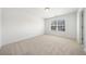 Neutral bedroom with a large window and a neutral carpet at 1151 Nash Lee Sw Dr, Lilburn, GA 30047