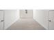 An open view of a bedroom shows neutral carpeting and dual closets flanking a window at 1151 Nash Lee Sw Dr, Lilburn, GA 30047