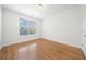 Clean bedroom featuring a window with blinds and light hardwood floors at 1151 Nash Lee Sw Dr, Lilburn, GA 30047