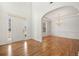 Bright foyer with hardwood floors leading to arched entryway and a dining room with wainscoting at 1151 Nash Lee Sw Dr, Lilburn, GA 30047