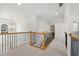An upstairs hallway with decorative railing and archways provides a spacious and bright walkway at 1151 Nash Lee Sw Dr, Lilburn, GA 30047
