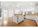 Bright kitchen boasts white cabinetry, hardwood floors, stainless steel appliances, and backyard views at 1151 Nash Lee Sw Dr, Lilburn, GA 30047