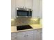 Modern kitchen with smooth cooktop and ample cabinet space at 1151 Nash Lee Sw Dr, Lilburn, GA 30047