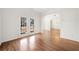 Bright living room featuring hardwood floors, french doors and arched doorway at 1151 Nash Lee Sw Dr, Lilburn, GA 30047