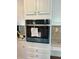 Built-in oven with stainless steel finish and white cabinets at 1151 Nash Lee Sw Dr, Lilburn, GA 30047