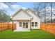 Spacious backyard featuring a well-maintained lawn, wood fence, and a covered patio area at 395 W Lake Nw Ave, Atlanta, GA 30318