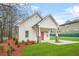 Beautifully landscaped front yard with mature trees and a freshly painted exterior at 395 W Lake Nw Ave, Atlanta, GA 30318