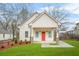 Charming home with a red door, covered porch, and well-manicured lawn at 395 W Lake Nw Ave, Atlanta, GA 30318