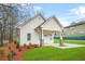 A single Gathering home with well-maintained lawn and mulched flower beds adding to the curb appeal at 395 W Lake Nw Ave, Atlanta, GA 30318