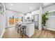 Bright kitchen with white cabinets, stainless steel appliances, island with seating, and wood floors at 395 W Lake Nw Ave, Atlanta, GA 30318